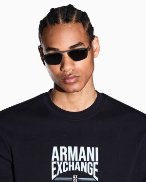 Man wearing black sunglasses and a black Armani Exchange sweatshirt with a bold white logo on the chest.
